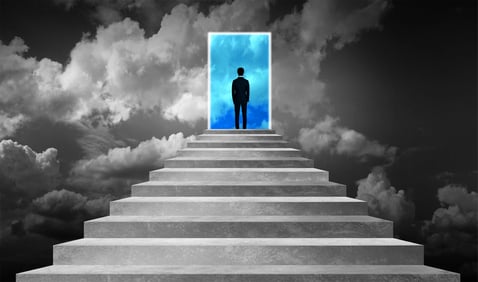 Success_Concept_-_Businessman_on_Stairway_With_Opened_Door_Into_Blue_Skies