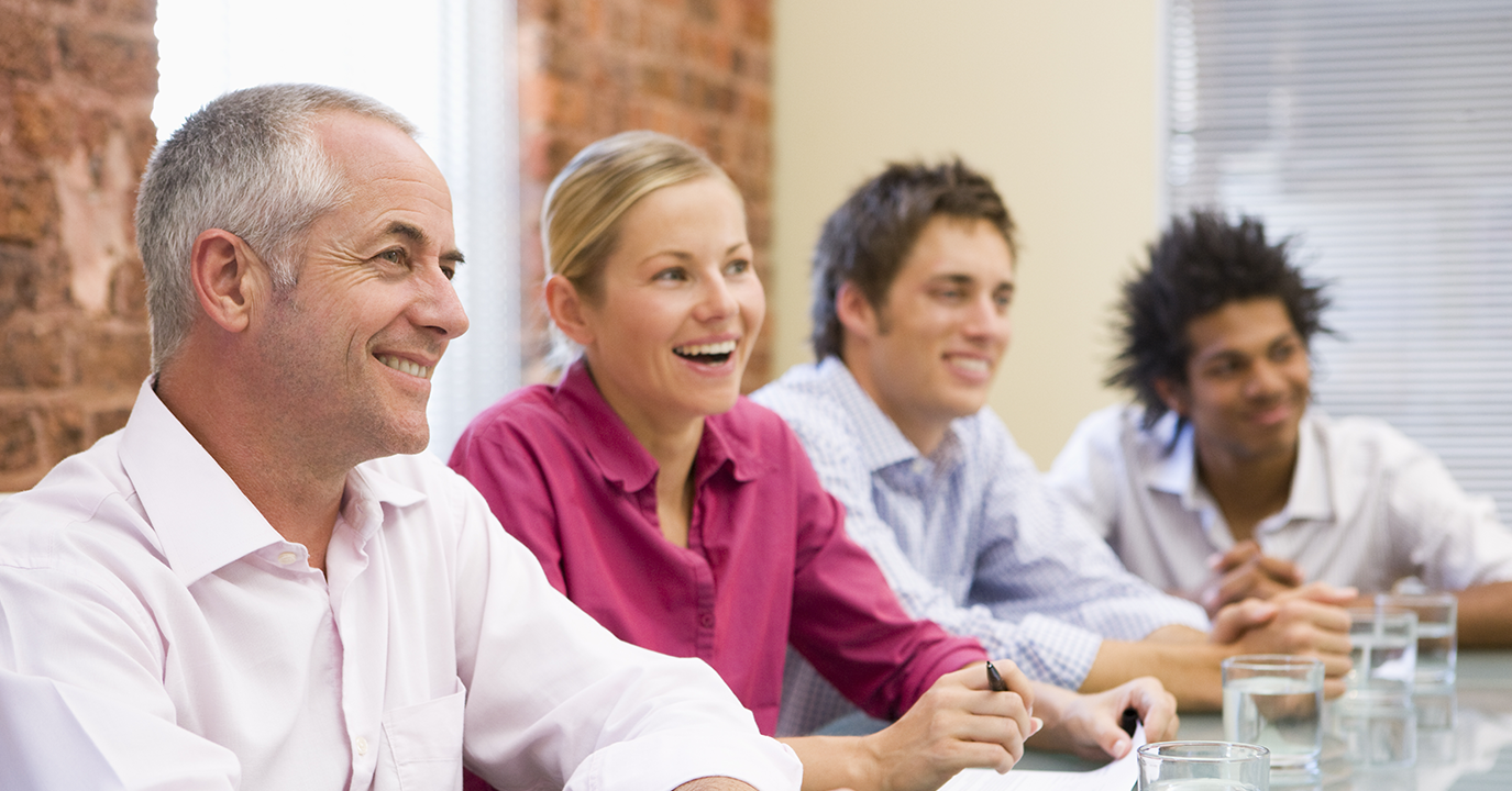 Storyblocks-four-businesspeople-in-boardroom-smiling_BYHc3JCBo-1375x720